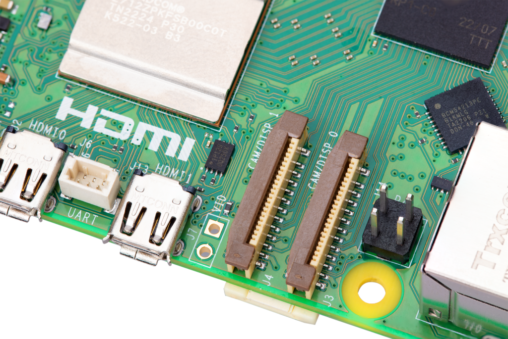 Close-up photo of part of the Raspberry Pi 5 board, centring the two FPC connectors, labelled CAM/DISP 0 and CAM/DISP 1