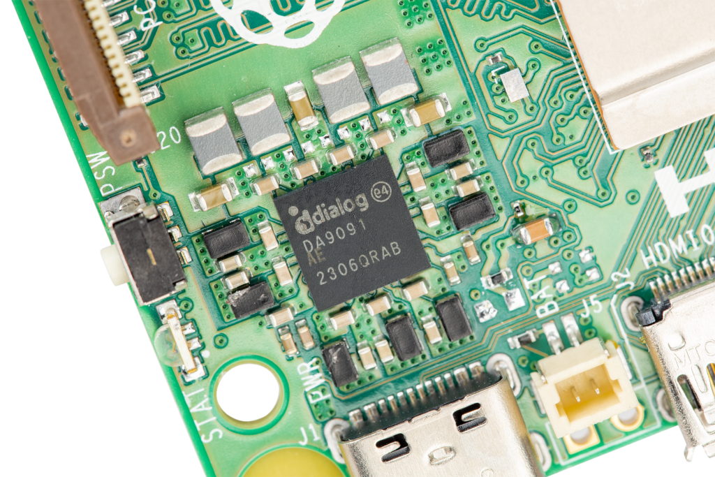 Close-up photo of part of the Raspberry Pi 5 board, centring the DA9091 power-management IC, on which its name is printed